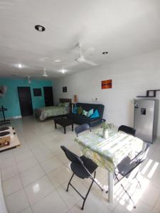 a living room with a table and chairs and a couch at Departamento Centrico La Ria in Campeche +2 photos