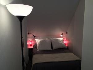 Un dormitorio con una cama con dos luces rojas. en La Plage en Normandie, en Pourville-sur-Mer 36 fotos más