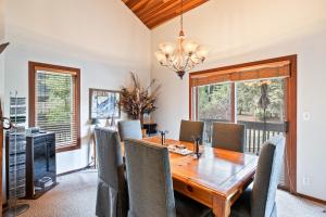 a dining room with a wooden table and chairs at Serene Location, 2min to Deer Valley, 3BR townhome! Perfect for Ski & Summer Adventures! in Park City