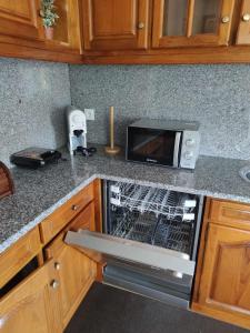a kitchen with a toaster oven and a microwave at Casinha da Eira in Monção +7 photos