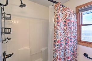 a bathroom with a shower with a shower curtain at Rapid City Home - Walk to Canyon Lake Park in Rapid City +20 photos