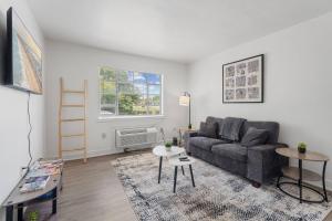 a living room with a couch and a table at 20 Minute Walk to Tiger Stadium / King Bed in Beaulieu