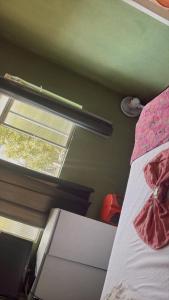a bed in a room with a window at hotel laren in Sete Lagoas +7 photos