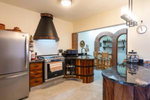 a kitchen with a refrigerator and a stove top oven at Los Amores 09 in Bucerías +8 photos