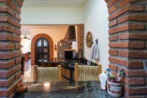 a kitchen and living room with a brick wall at Los Amores 09 in Bucerías