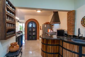 a kitchen with a counter and a refrigerator at Los Amores 09 in Bucerías
