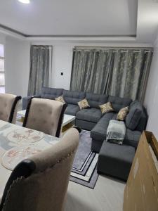a living room with a couch and a table at 2bedroom house along waiyaki way in Nairobi