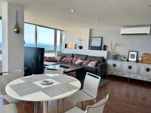 a living room with a table and a couch at ROSAS Vue sur Mer in Roses