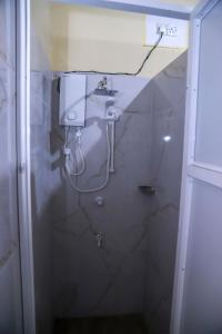a bathroom with a sink and a marble wall at Stellar Bunks in Peradeniya