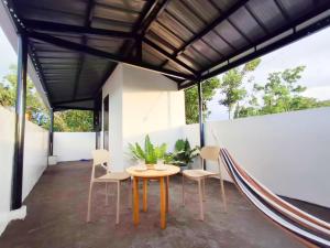 a patio with a table and chairs and a hammock at Apartelle 386 in Dipolog