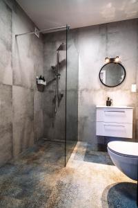 a bathroom with a shower and a toilet and a sink at Morze Apartamentów Apartament West Łeba A20 in Łeba