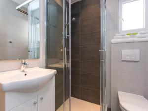 a bathroom with a sink and a glass shower at Guest house Mazuth in Rab +20 photos