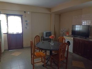 a kitchen with a table and chairs and a television at Alojamiento temporal - Alto Comedero in San Salvador de Jujuy