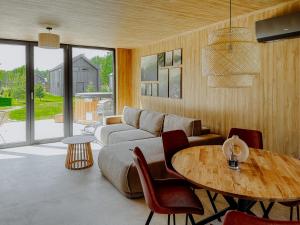 a living room with a couch and a table at Leśna Polana Górajek in Chycza