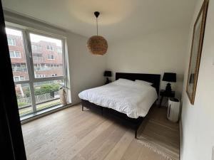 a bedroom with a bed and a large window at Royal Touch Studio Brussels in Brussels