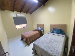 a bedroom with two beds and a flat screen tv at Duplex a estrenar Alojamiento entero in Cambyretá