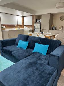 a blue couch with two blue pillows in a kitchen at Complejo EL PAÑIL in Lago Puelo