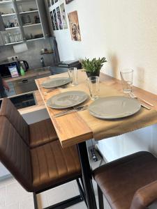 a kitchen with a table with plates on it at Ferienwohnung am Hoeschplatz in Düren - Eifel