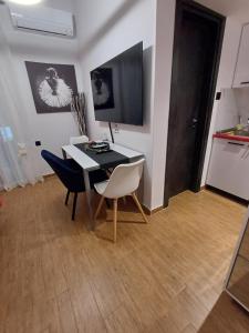a dining room with a table and two chairs at Rafina's BLUE HEART! Steps from the beach,2 min walk - WALK to Rafina main square 10 min, and Port about 15 min walk ! Ideal vacation base! in Rafina