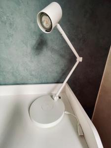 a bathroom with a toilet with a light on it at Appartement 80m2 à deux pas du beffroi in Arras +26 photos