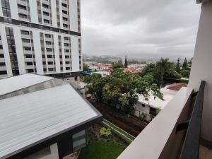 a view of a city from the balcony of a building at Funcional, céntrico, El Oasis Urbano in Tegucigalpa