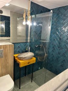 a bathroom with a sink and a glass shower at Gryfon Dom in Jastarnia +7 photos