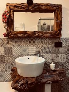 a bathroom with a white sink and a mirror at Chalet Lumière Alpine in La Salle +25 photos