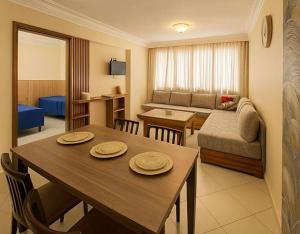 a room with a dining table and a living room at Apparts-hôtel ISNI in Agadir +17 photos