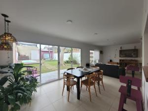 a dining room and kitchen with a table and chairs at Casa céntrica con piscina in Paraná