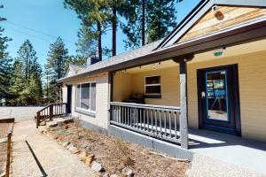 a yellow house with a porch and a door at The Chalet at Kings Beach Unit 6 in Kings Beach