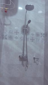 a shower with a shower head in a bathroom at Ritz luxourious apartments in Kampala