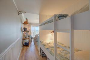 a room with two bunk beds and a hallway at Topsail Dunes 1107 in North Topsail Beach