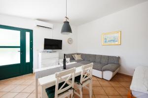 a living room with a table and a couch at Karantanovi Dvori in Murter