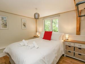 a bedroom with a white bed and a window at Roman Lodge in Weymouth