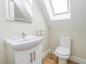 a bathroom with a sink and a toilet at Roman Lodge in Weymouth +23 photos