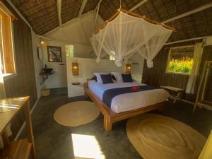 a bedroom with a bed in a room with rugs at Dicilaba Lodge in Sainte Marie