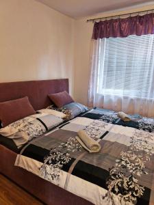 a bedroom with a large bed with a window at New fast apartment in Levice