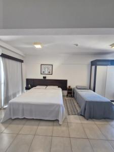 a large bedroom with two beds in it at Flat com Vista Panorâmica in Bauru