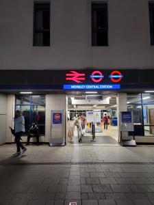 a subway station with people walking in front of it at London Wembley Luxury Stay 2BR Apartment next to stadium with Free Parking in London