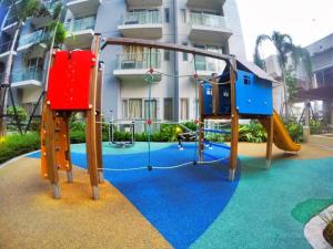 a playground in front of a building at Palm Tree Villas by Ann in Manila