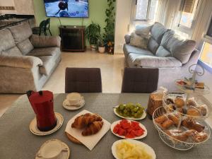 a living room with a table with plates of food at Room Lidón Center 1 in Castellón de la Plana