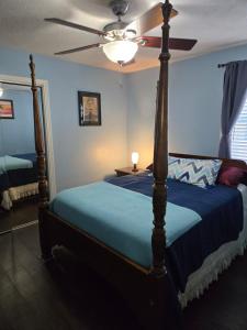 a bedroom with a bed with a ceiling fan at Hist Two Bedroom Home in Avondale Riverside Jacksonville in Jacksonville