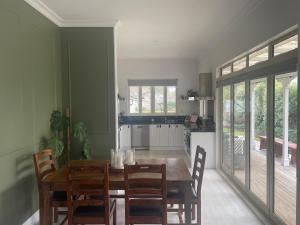 a dining room with a wooden table and chairs at Picture Perfect in the heart of the Village in Greytown +15 photos