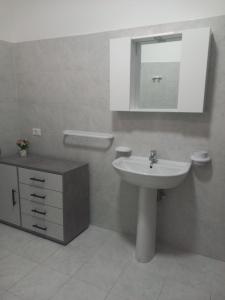 a bathroom with a sink and a mirror at Casa Vacanze del Salento in Sava