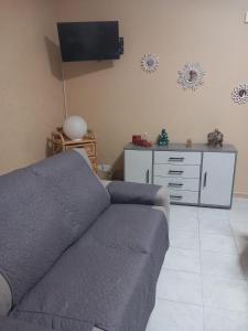 a living room with a couch and a tv at Casa Vacanze del Salento in Sava