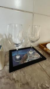 twee lege wijnglazen op een tafel bij Ótima suíte privativa no Centro Histórico in Goiás
