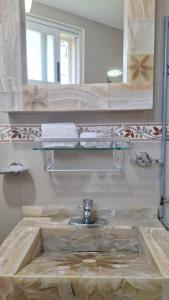 a bathroom with a sink and a mirror at Little House Downtown Morelia in Morelia +11 photos