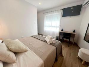 ein Schlafzimmer mit Bett, Schreibtisch und Fenster in der Unterkunft Thor Hostal Boutique in Alicante