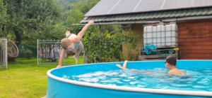 a young girl is playing in a swimming pool at Villa Ortus in Novoselitsa