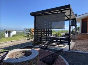 a pavilion with chairs and a fire pit in a yard at Tierra Linda in León